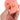 Hand holding a pink pig-shaped stress reliever toy against a white background