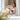 Woman with a dog on a wooden floor in a bright room fitting a Flexi New Comfort Large Tape Retractable Dog Leash to a golden lab dog