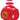 A red translucent Kong Jumbler dog toy with a handle, shown with its retail hang tag on a plain white background.