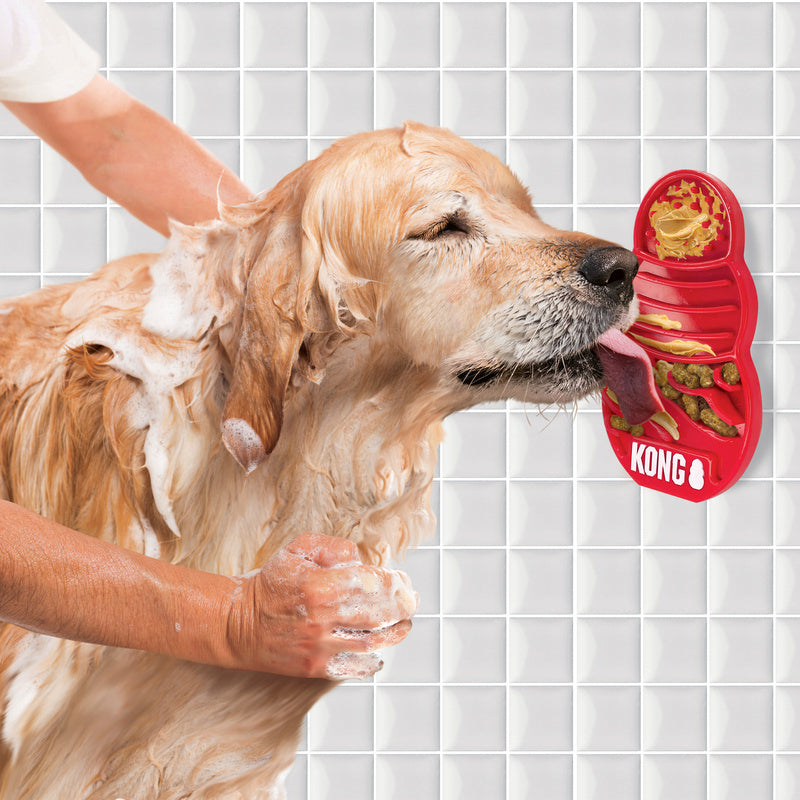 dog being bathed using Kong Licks Mat Slow Feeder, golden retriever using lickimat, pet essentials warehouse